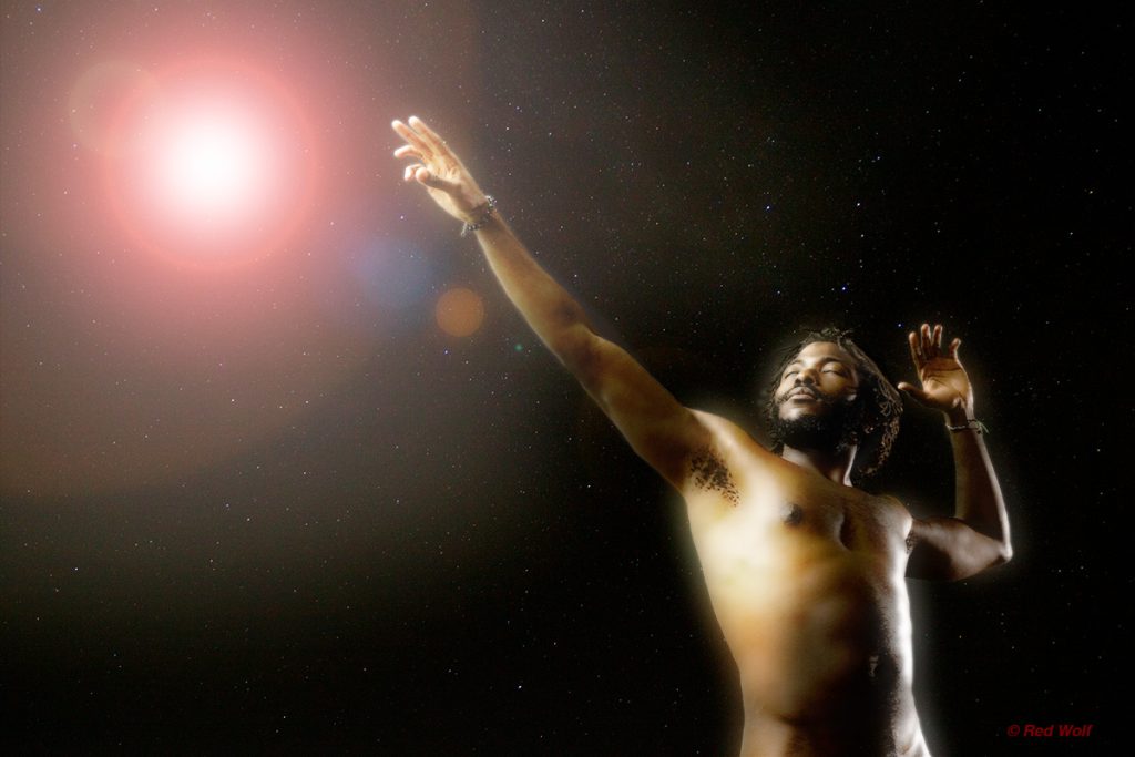 Reach for the Stars - Image by RedWolf of a Man Reaching toward a light in the night sky